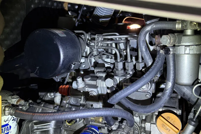 Engine compartment of a 2010 Beneteau Oceanis 37 sailboat, showcasing mechanical components.