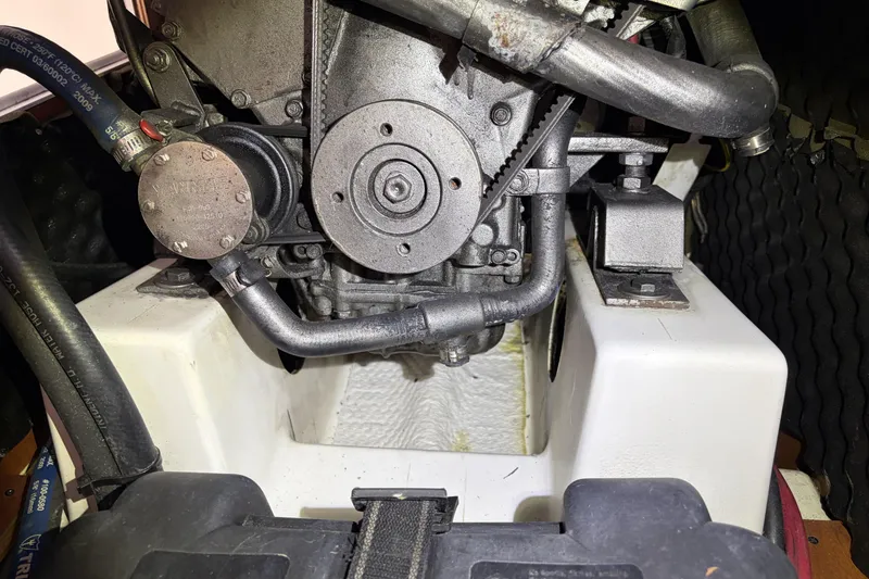 Engine compartment of a 2010 Beneteau Oceanis 37 sailboat, showcasing mechanical components.