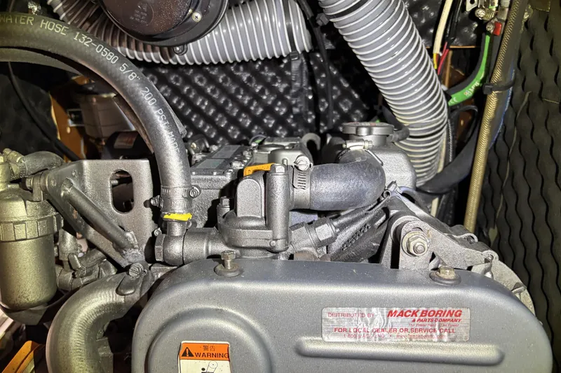 Engine compartment of a 2010 Beneteau Oceanis 37 sailboat, showcasing detailed mechanical components.
