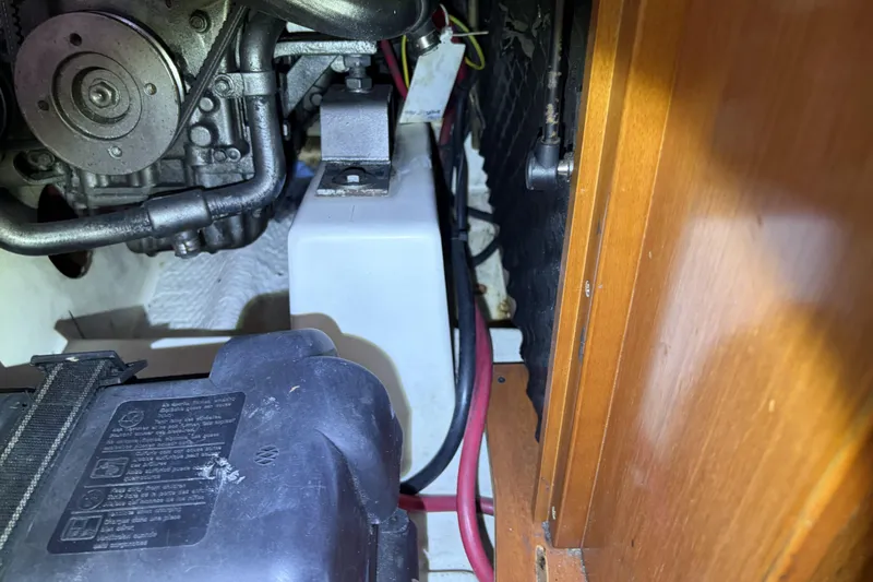 Engine compartment of a 2010 Beneteau Oceanis 37 sailboat, showing mechanical components and wiring.