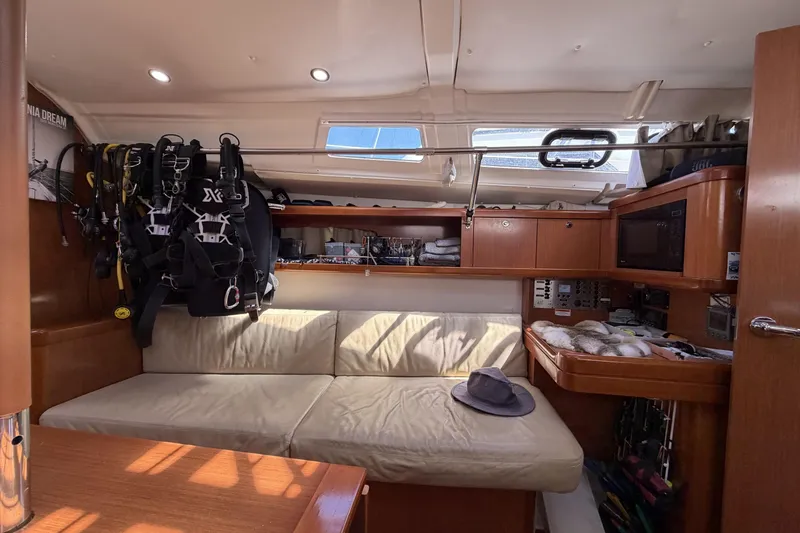 Interior of a 2010 Beneteau Oceanis 37 sailboat with cozy seating and equipment.