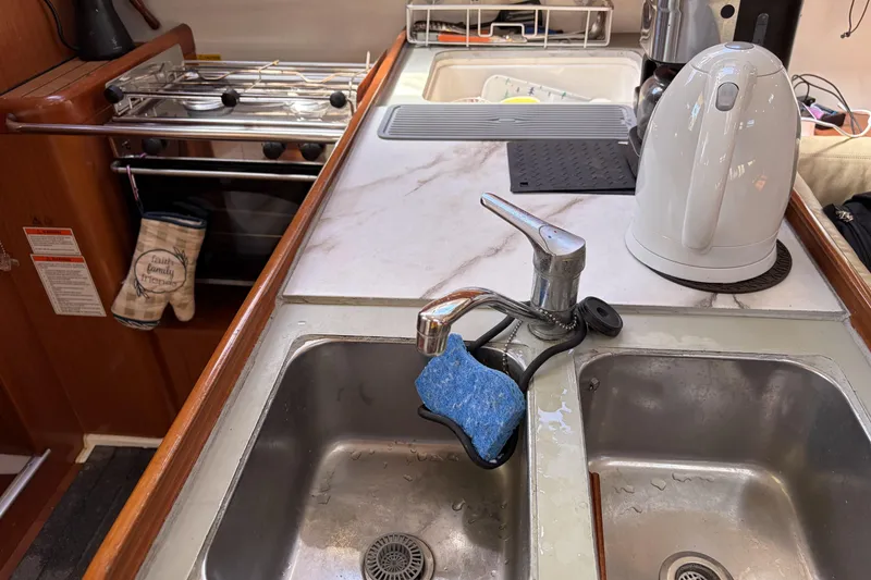 Galley kitchen in 2010 Beneteau Oceanis 37 sailboat with sink and kettle.
