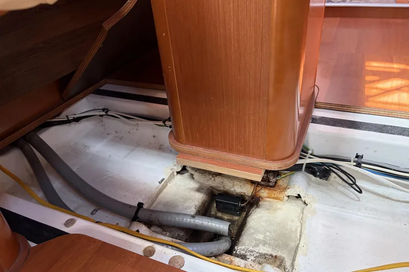 Interior view of a 2010 Beneteau Oceanis 37 sailboat, showing exposed wiring and pipes.