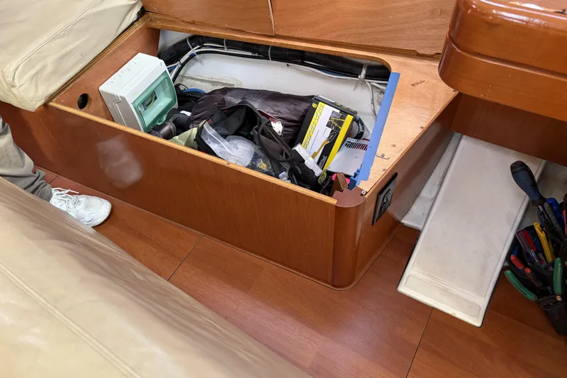 Storage compartment on a 2010 Beneteau Oceanis 37 sailboat with tools and equipment.