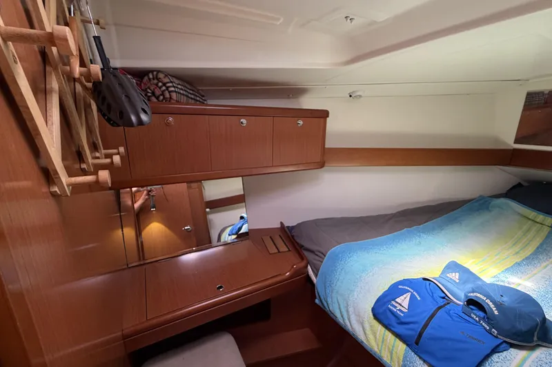 Cozy cabin interior of 2010 Beneteau Oceanis 37 sailboat with wooden furnishings.