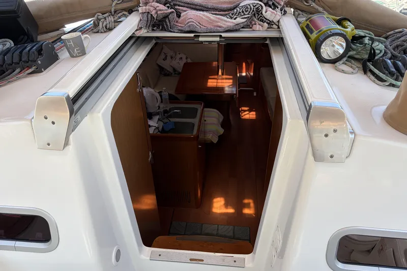 Interior view of 2010 Beneteau Oceanis 37 sailboat, showing cabin entrance and deck details.