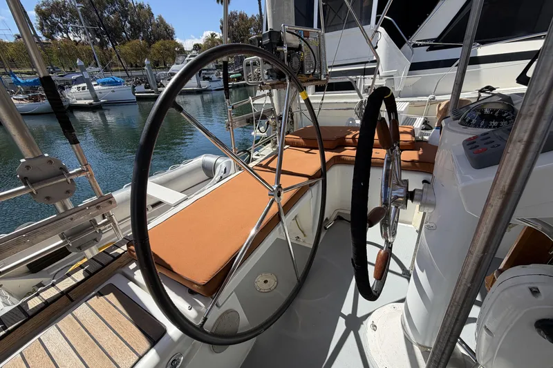 Cockpit of 2010 Beneteau Oceanis 37 sailboat with dual steering wheels and cushioned seating.