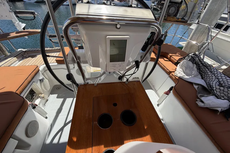 Cockpit of 2010 Beneteau Oceanis 37 sailboat with steering wheel and navigation equipment.