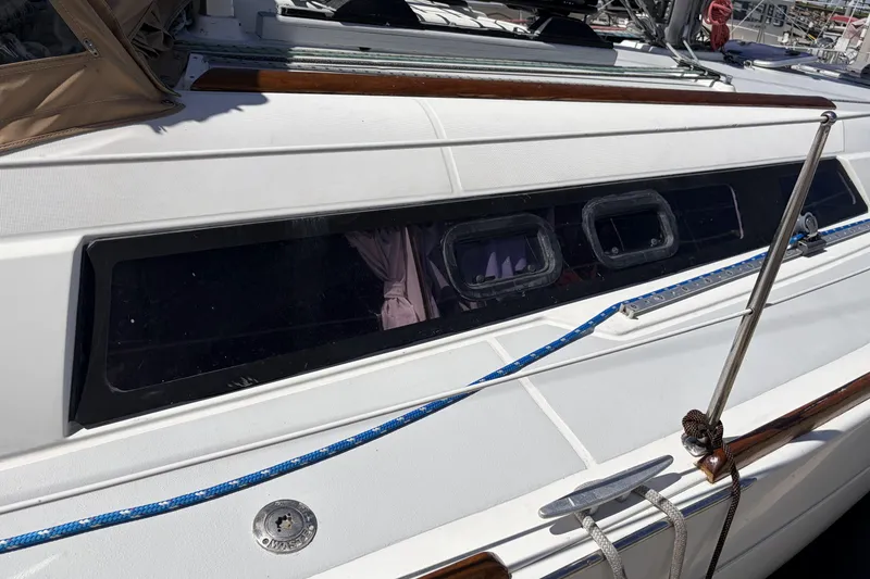 2010 Beneteau Oceanis 37 sailboat deck with windows and blue rope detail.