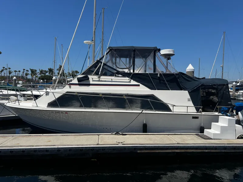 1982 Carver Mariner 33 yacht docked at marina under clear blue sky.