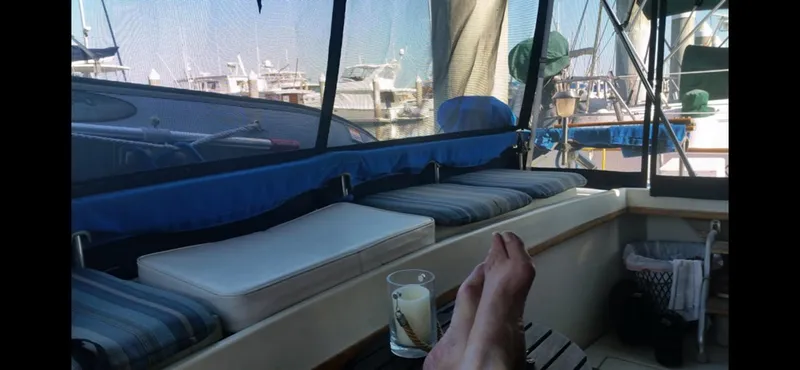 Relaxing on a 1982 Carver Mariner 33 yacht with marina view.