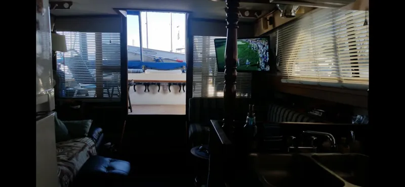 Interior of 1982 Carver Mariner 33 yacht with cozy seating and TV.