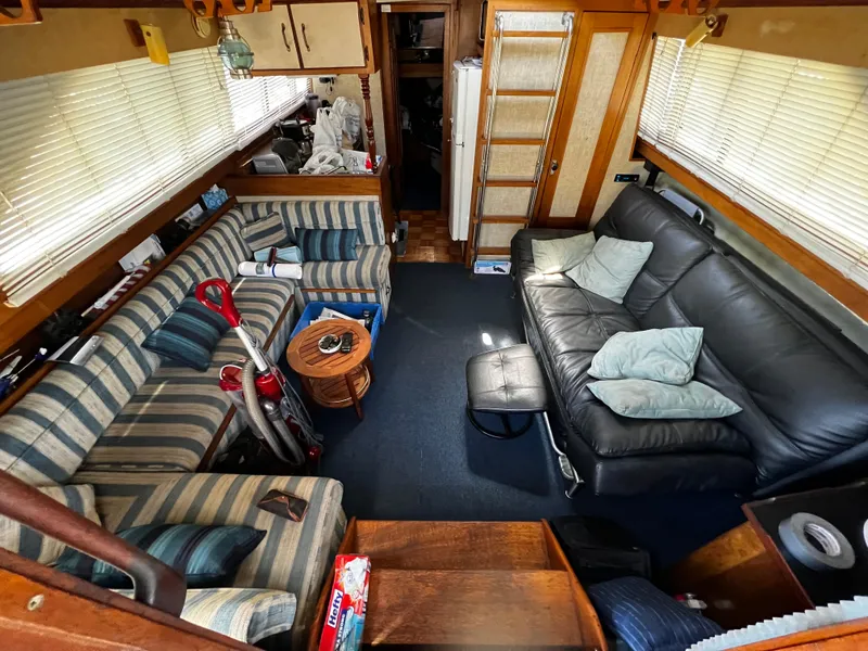 Interior of 1982 Carver Mariner 33 with striped and leather seating, cozy and inviting.