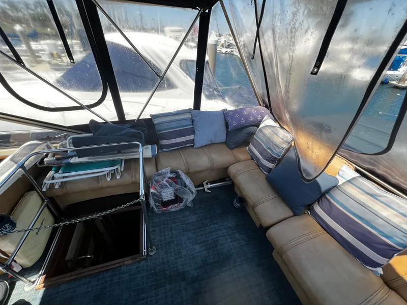 1982 Carver Mariner 33 boat interior with cushioned seating and nautical decor.