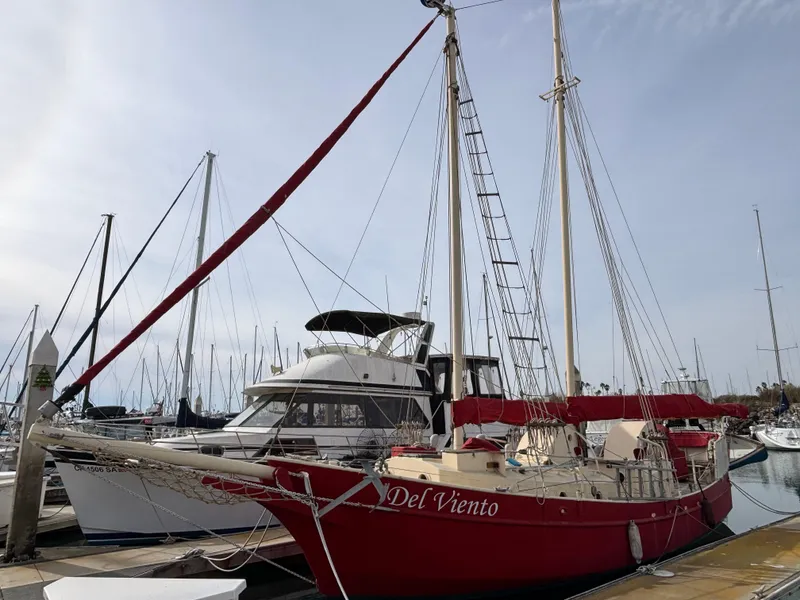 Red 1975 Custom 45’ Thomas Colvin “Tamarack” Schooner docked at marina.
