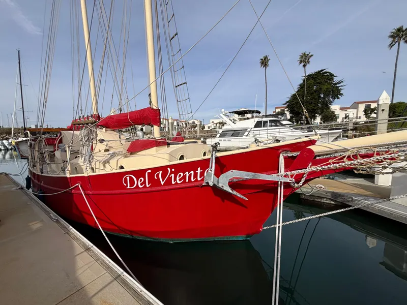 Red 1975 Custom 45’ Thomas Colvin “Tamarack” Schooner docked at marina.