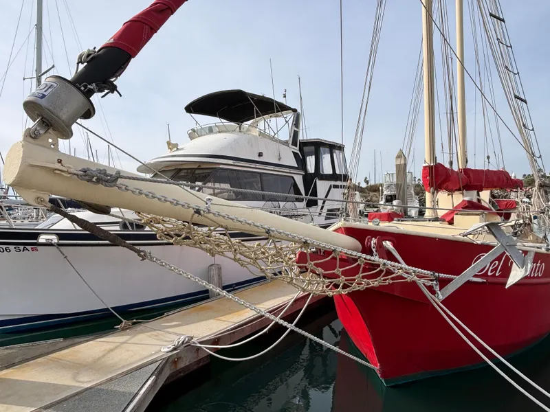 Red 1975 Custom 45’ Thomas Colvin “Tamarack” Schooner docked at marina.