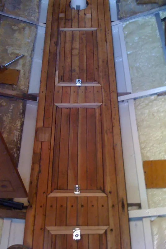 Wooden interior of 1975 Custom 45’ Thomas Colvin “Tamarack” Schooner with secured compartments.
