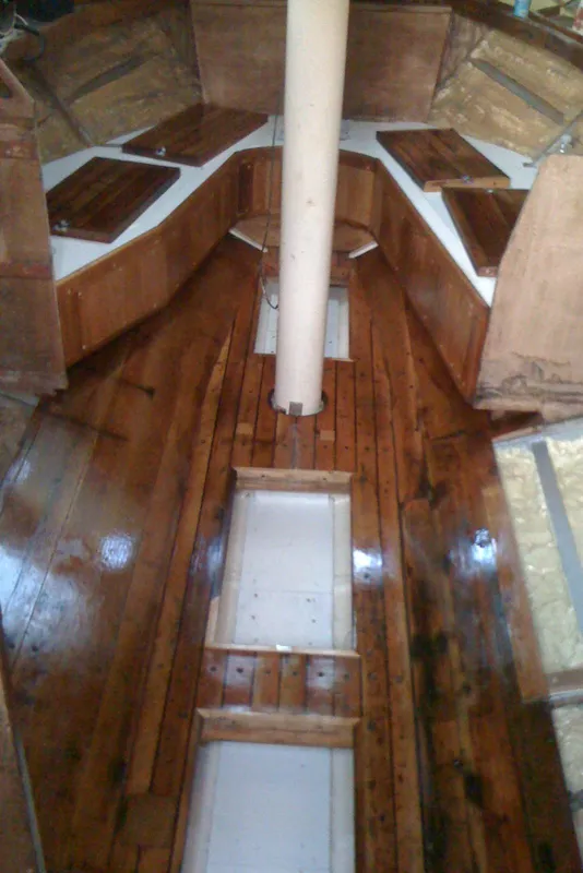 Interior of 1975 Custom 45’ Thomas Colvin “Tamarack” Schooner with polished wooden flooring.