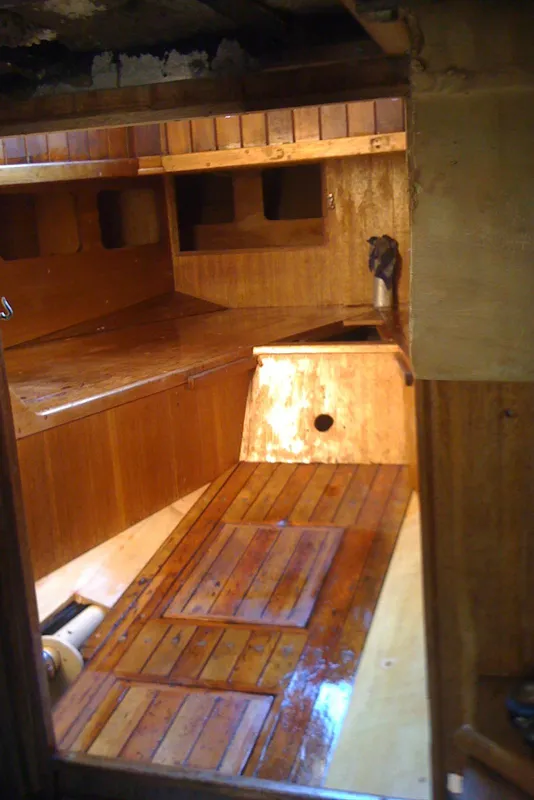 Interior of 1975 Custom 45’ Thomas Colvin “Tamarack” Schooner with polished wooden finish.