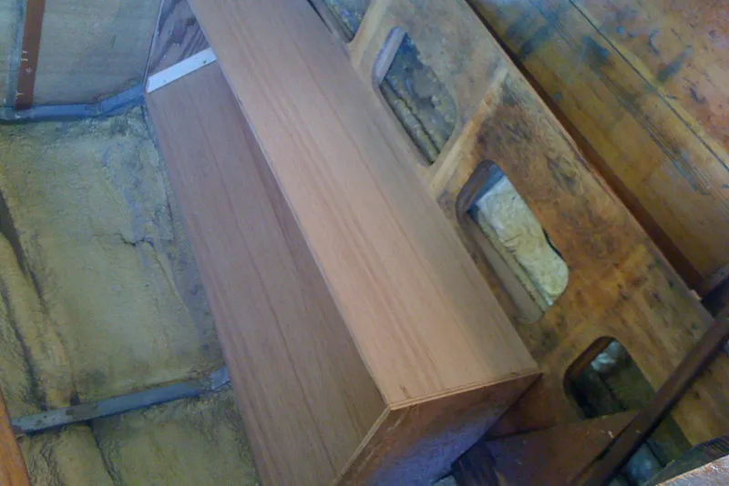 Interior view of 1975 Custom 45’ Thomas Colvin “Tamarack” Schooner with wooden bench and exposed framework.