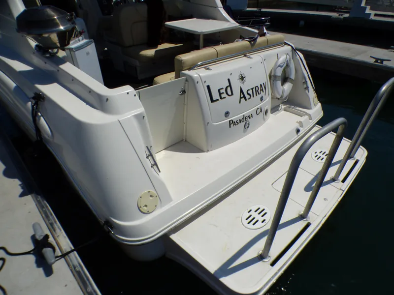 2001 Monterey 302 Cruiser boat docked, featuring rear deck and seating area.