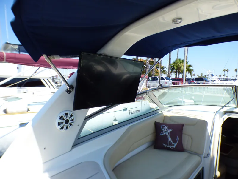 2001 Monterey 302 Cruiser interior with TV, speaker, and anchor-themed pillow.