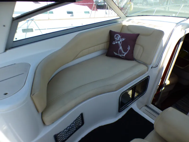 2001 Monterey 302 Cruiser interior with beige seating and anchor-themed pillow.