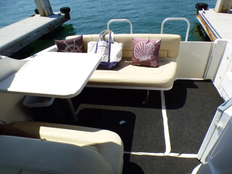 2001 Monterey 302 Cruiser interior with seating, table, and nautical-themed pillows.