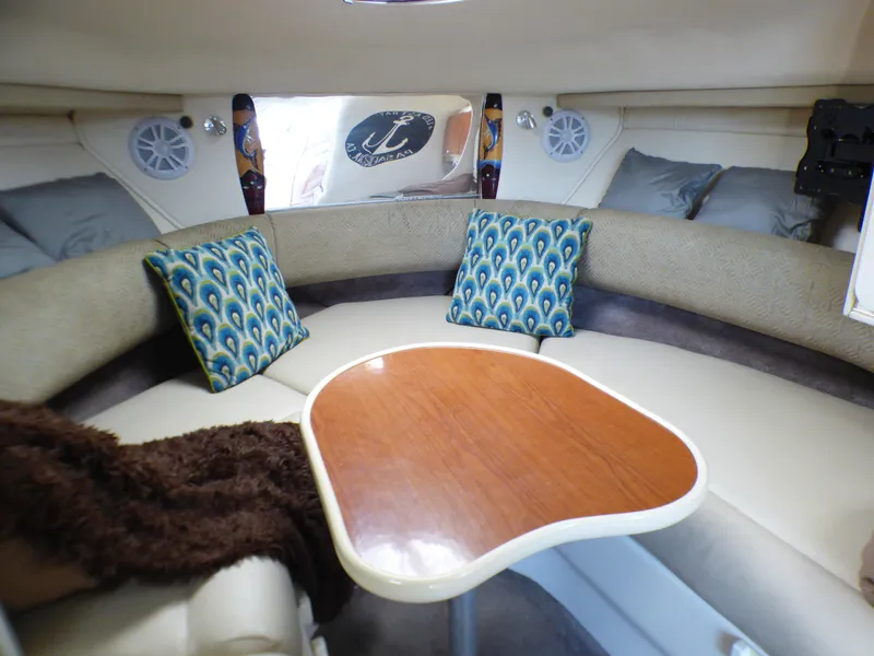 Interior of 2001 Monterey 302 Cruiser with cozy seating and decorative pillows.