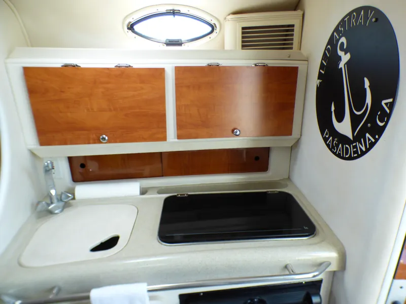 2001 Monterey 302 Cruiser kitchen area with wooden cabinets and sink.