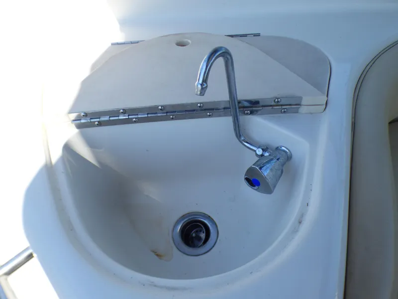 2001 Monterey 302 Cruiser sink with chrome faucet in boat interior.