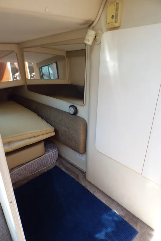 Interior cabin of 2001 Monterey 302 Cruiser with beige upholstery and blue carpet.
