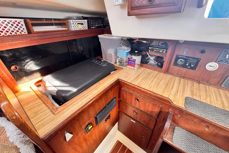 1979 O'Day 37 Center Cockpit interior with wooden cabinetry and navigation equipment.