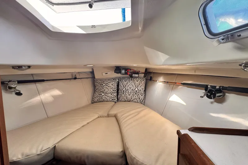 1979 O'Day 37 Center Cockpit interior with cozy V-berth and fishing rods.