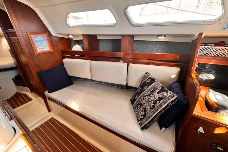 1979 O'Day 37 Center Cockpit interior with cozy seating and decorative pillows.