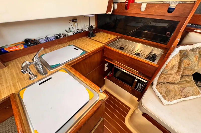 1979 O'Day 37 Center Cockpit galley with sink, stove, and microwave.