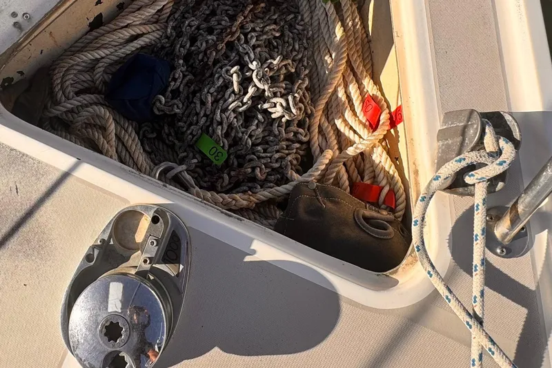 Anchor locker of 1979 O'Day 37 Center Cockpit with ropes and chains.
