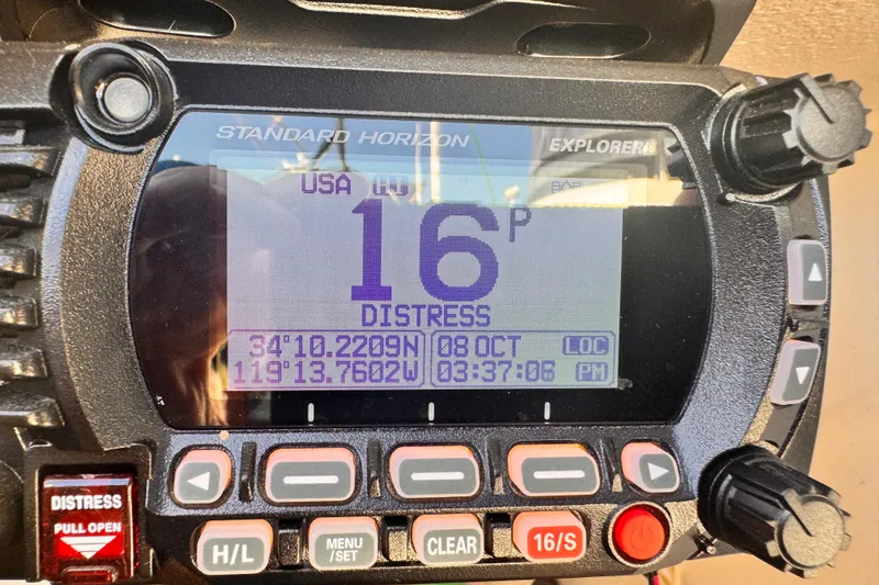 Standard Horizon Explorer marine radio displaying distress signal coordinates.