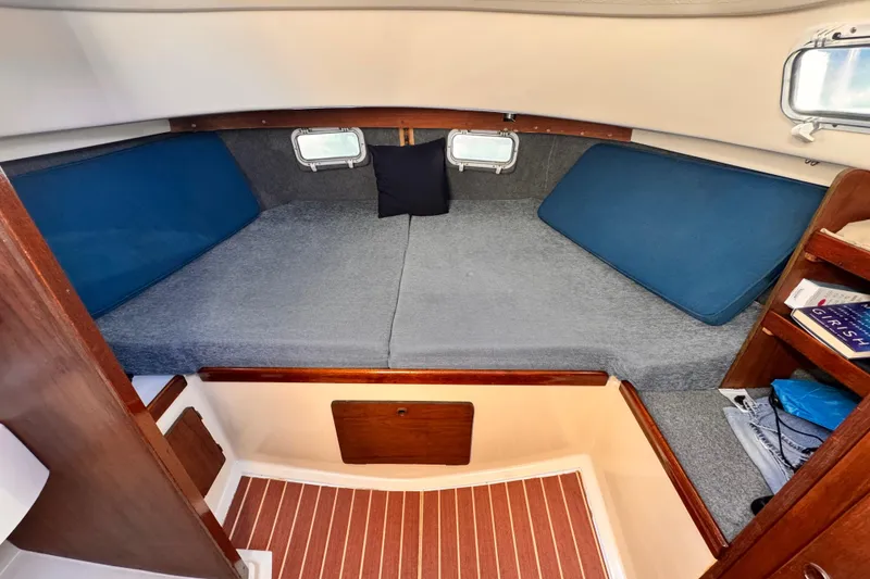 Cozy cabin interior of 1979 O'Day 37 Center Cockpit sailboat with comfortable bedding.