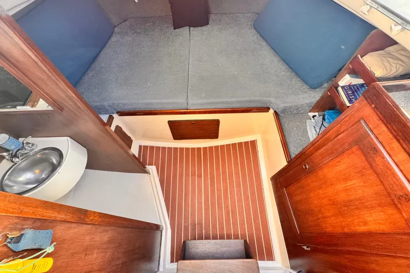 1979 O'Day 37 Center Cockpit interior with wooden cabinetry and compact sink.