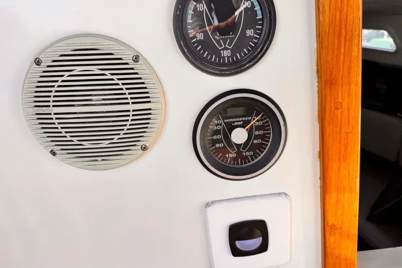 Instrument panel on a 1979 O'Day 37 Center Cockpit sailboat, featuring gauges and speaker.