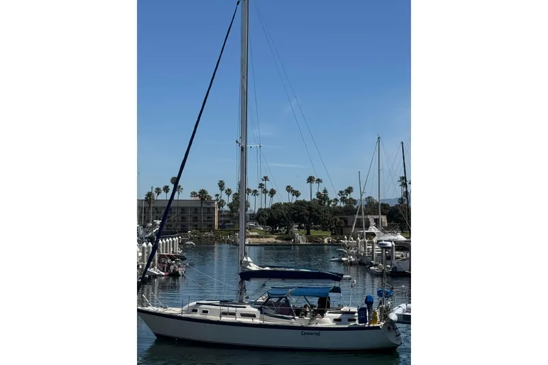 1979 O'Day 37 Center Cockpit sailboat docked in a sunny marina.