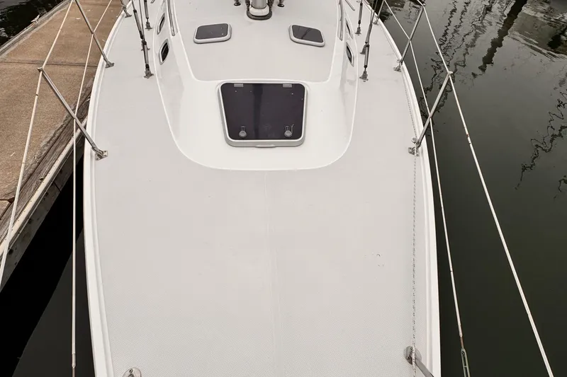 2001 Catalina 36 MkII sailboat deck view, docked, with visible hatch and railing.