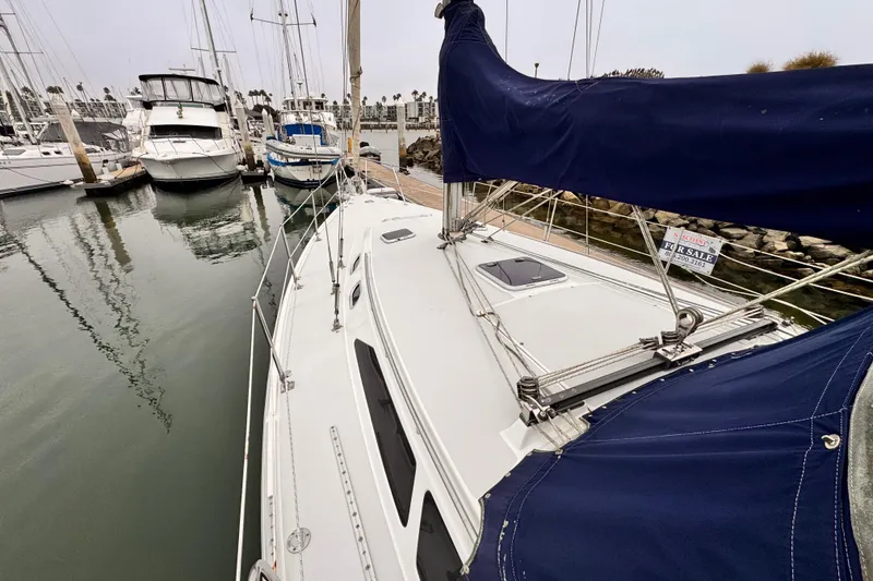 2001 Catalina 36 MkII sailboat docked, featuring blue sail cover and "For Sale" sign.