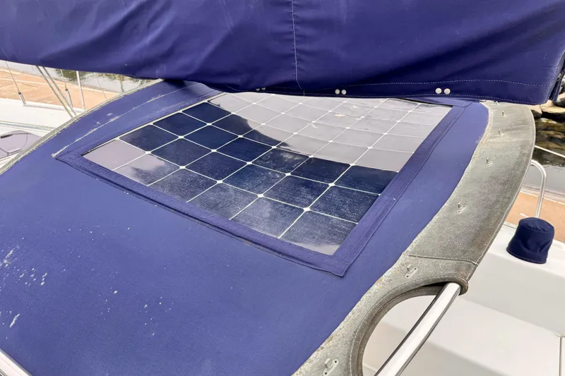 Solar panel on 2001 Catalina 36 MkII sailboat with blue canvas cover.