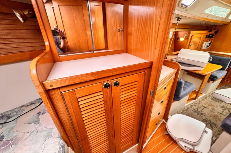 Interior of 2001 Catalina 36 MkII sailboat with wooden cabinetry and seating area.
