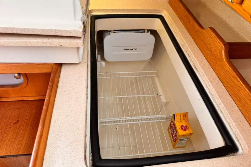 Interior of 2001 Catalina 36 MkII yacht showing a Dometic fridge with baking soda.