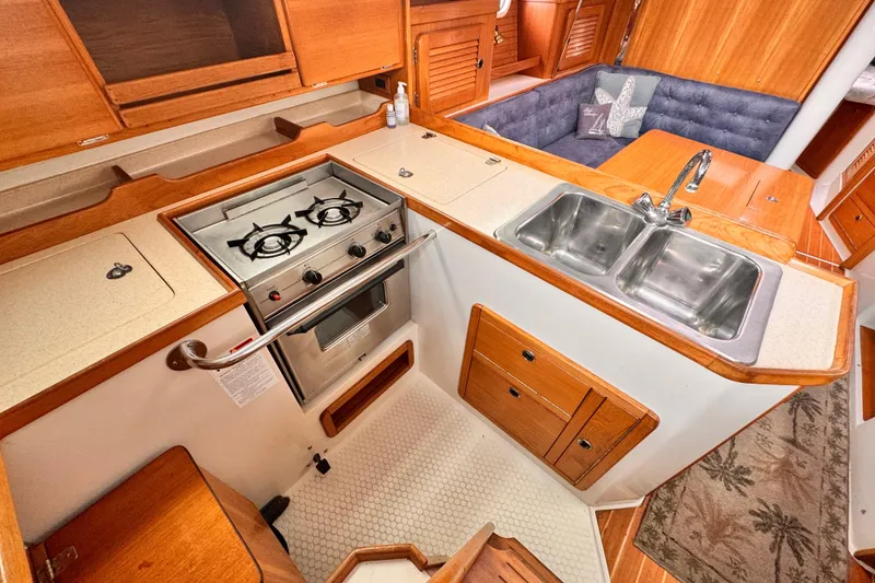 Galley kitchen in 2001 Catalina 36 MkII sailboat with stove and double sink.