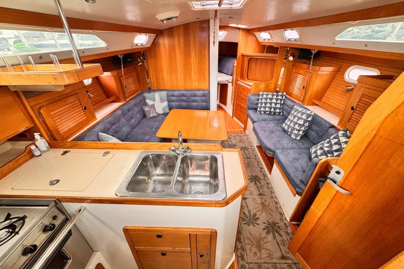 Interior of a 2001 Catalina 36 MkII sailboat with cozy seating and kitchen area.